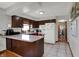 Functional kitchen featuring wood cabinets, a breakfast bar, and tile flooring for easy maintenance at 1111 Cambridge Dr, Greenwood, IN 46142