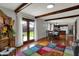 Bright living room featuring wood beams, hardwood floors, and sliding doors to the backyard at 1111 Cambridge Dr, Greenwood, IN 46142