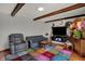 Comfortable living room with a brick fireplace, colorful rug, and relaxed seating arrangement at 1111 Cambridge Dr, Greenwood, IN 46142