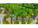 An aerial view showcases homes with pools and manicured yards in a tranquil, leafy neighborhood at 1124 Enchanted View Dr, Mooresville, IN 46158