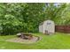 Backyard featuring a storage shed, patio with picnic table and a grill for outdoor enjoyment at 1124 Enchanted View Dr, Mooresville, IN 46158
