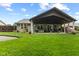 A covered patio area provides a relaxing space for outdoor living with a well-maintained lawn at 1124 Enchanted View Dr, Mooresville, IN 46158