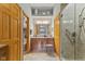 Bathroom featuring wood cabinets, decorative shelves, and glass enclosed shower at 1124 Enchanted View Dr, Mooresville, IN 46158