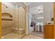 Glass shower with tile surround adjacent to a bedroom featuring light walls and a bright window at 1124 Enchanted View Dr, Mooresville, IN 46158