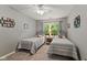 Neutral bedroom featuring two twin beds with blue and white bedding, and natural light from the window at 1124 Enchanted View Dr, Mooresville, IN 46158