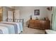 This bedroom features a dresser and framed picture adding a personal touch to the neutral-toned space at 1124 Enchanted View Dr, Mooresville, IN 46158