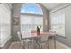Bright breakfast nook features a large arched window and stylish vintage table set at 1124 Enchanted View Dr, Mooresville, IN 46158