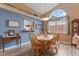 Bright dining area featuring a large arched window, wood table, and blue accent wall with decorative shelving at 1124 Enchanted View Dr, Mooresville, IN 46158
