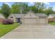 Charming brick home boasts a well-manicured lawn and attached three car garage at 1124 Enchanted View Dr, Mooresville, IN 46158