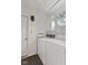 Well-lit laundry room with washer, dryer, storage cabinet, and convenient door access at 1124 Enchanted View Dr, Mooresville, IN 46158