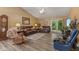 Comfortable living room with leather furniture, a ceiling fan, and sliding doors leading to the outside at 1124 Enchanted View Dr, Mooresville, IN 46158