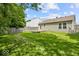 Lush backyard features a wooden deck and mature trees for added privacy at 11821 Wapiti Way, Noblesville, IN 46060