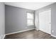 Light-filled bedroom with gray walls, wood-look flooring, and a closet at 11821 Wapiti Way, Noblesville, IN 46060