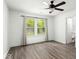 Bright bedroom with wood-look flooring, ceiling fan, and natural light from the double window at 11821 Wapiti Way, Noblesville, IN 46060