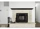 Detailed fireplace with decorative mantel, tile work, and hearth with black hardware. Laminate flooring throughout at 11821 Wapiti Way, Noblesville, IN 46060