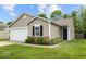 Charming single-Gathering home features an attached garage and manicured lawn at 11821 Wapiti Way, Noblesville, IN 46060