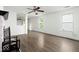 Inviting living room showcasing durable laminate flooring, abundant natural light, and a partial view of the kitchen at 11821 Wapiti Way, Noblesville, IN 46060