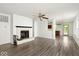 Bright living room featuring a fireplace, ceiling fan, and durable laminate flooring throughout the home at 11821 Wapiti Way, Noblesville, IN 46060