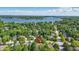 Beautiful aerial view of a home nestled in a tree-filled neighborhood with a lake in the background at 12335 Old Stone Dr, Indianapolis, IN 46236