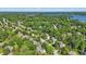 Scenic aerial view of a residential area surrounded by lush greenery and a shimmering lake in the distance at 12335 Old Stone Dr, Indianapolis, IN 46236