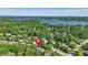 Expansive aerial view of property surrounded by mature trees and a serene lake in the distance at 12335 Old Stone Dr, Indianapolis, IN 46236