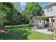 Lush backyard with a well-maintained lawn, mature trees, and an outdoor grill area at 12335 Old Stone Dr, Indianapolis, IN 46236