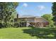 Picturesque backyard featuring a screened porch, outdoor dining area, and large lawn at 12335 Old Stone Dr, Indianapolis, IN 46236
