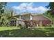 Backyard view with a screened porch, outdoor dining area, and well-manicured lawn at 12335 Old Stone Dr, Indianapolis, IN 46236