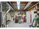 Unfinished basement with exposed utilities, storage items, and a potential for customization at 12335 Old Stone Dr, Indianapolis, IN 46236