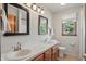 Bright bathroom with double sinks, a window with a view, and tiled floors at 12335 Old Stone Dr, Indianapolis, IN 46236