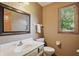 Well-lit bathroom featuring a modern vanity, neutral tones, and a framed mirror at 12335 Old Stone Dr, Indianapolis, IN 46236