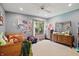 Bedroom with light blue walls, ceiling fan, window, bed and dressers at 12335 Old Stone Dr, Indianapolis, IN 46236
