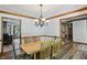 Open concept dining room with chandelier and convenient access to other rooms at 12335 Old Stone Dr, Indianapolis, IN 46236