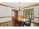 Bright dining room featuring a rustic wood table, elegant chandelier, and views of the outdoors at 12335 Old Stone Dr, Indianapolis, IN 46236