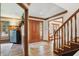 Elegant foyer features wood floors, staircase, and trim with an intricate entry rug at 12335 Old Stone Dr, Indianapolis, IN 46236