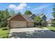 Beautiful brick and siding home featuring an attached two-car garage with a long driveway at 12335 Old Stone Dr, Indianapolis, IN 46236