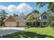 Charming two-story home with a well-manicured lawn, brick accents, and an attached two-car garage at 12335 Old Stone Dr, Indianapolis, IN 46236