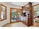 Breakfast nook with custom built-ins and sliding glass doors to sunroom at 12335 Old Stone Dr, Indianapolis, IN 46236