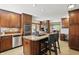 Open kitchen boasts a center island, stainless steel appliances, and custom cabinetry at 12335 Old Stone Dr, Indianapolis, IN 46236