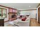 Cozy living room showcasing a brick fireplace and large windows at 12335 Old Stone Dr, Indianapolis, IN 46236