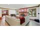 Bright living room featuring a brick fireplace, wood flooring, and a comfortable white sofa at 12335 Old Stone Dr, Indianapolis, IN 46236