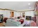 Spacious living room boasts natural light, fireplace, hardwood floors and comfortable seating at 12335 Old Stone Dr, Indianapolis, IN 46236
