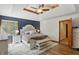 Calming main bedroom with tray ceiling, ceiling fan and an elegant bed at 12335 Old Stone Dr, Indianapolis, IN 46236