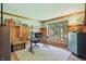 Well-lit home office featuring wood paneling, trim, a modern desk and comfortable seating at 12335 Old Stone Dr, Indianapolis, IN 46236