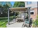 Inviting outdoor seating area featuring a pergola, dining table, and grill, perfect for entertaining at 12335 Old Stone Dr, Indianapolis, IN 46236