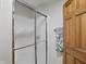 Bathroom with glass enclosed shower and wooden door at 12335 Old Stone Dr, Indianapolis, IN 46236