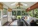 Relaxing sunroom with comfortable seating, a ceiling fan, and views of the green outdoors at 12335 Old Stone Dr, Indianapolis, IN 46236