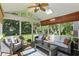 Cozy sunroom with comfortable seating, skylights, and views of the lush backyard at 12335 Old Stone Dr, Indianapolis, IN 46236