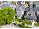 Aerial view of a charming two-story home with a welcoming front porch surrounded by trees and manicured landscaping at 1322 Marlowe Ave, Indianapolis, IN 46202