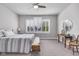Bright bedroom featuring neutral walls, gray carpet, ceiling fan and windows with white shutters at 1322 Marlowe Ave, Indianapolis, IN 46202